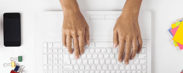 Image of a desk with coffee cup, paper, phone
